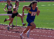 Lucy Flynn strides for the line at Manchester's Sportscity